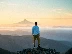 man standing on top of mountain